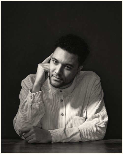 B&W portrait of man sitting at a table